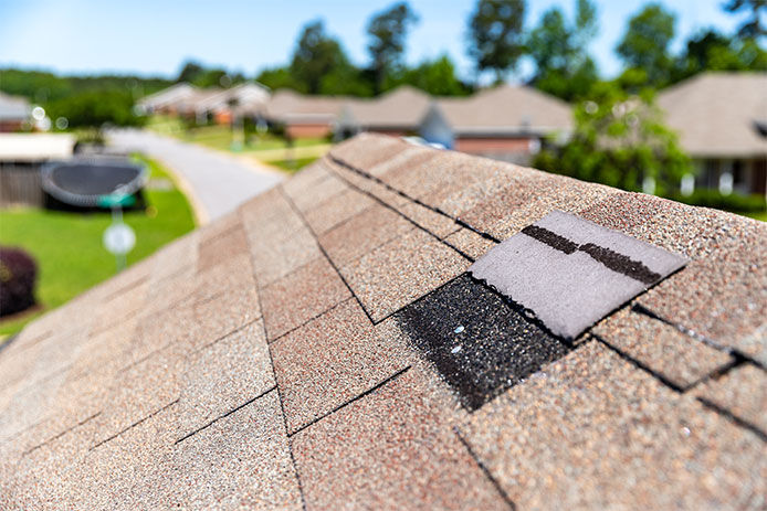 Missing shingles on roof due to storm damage