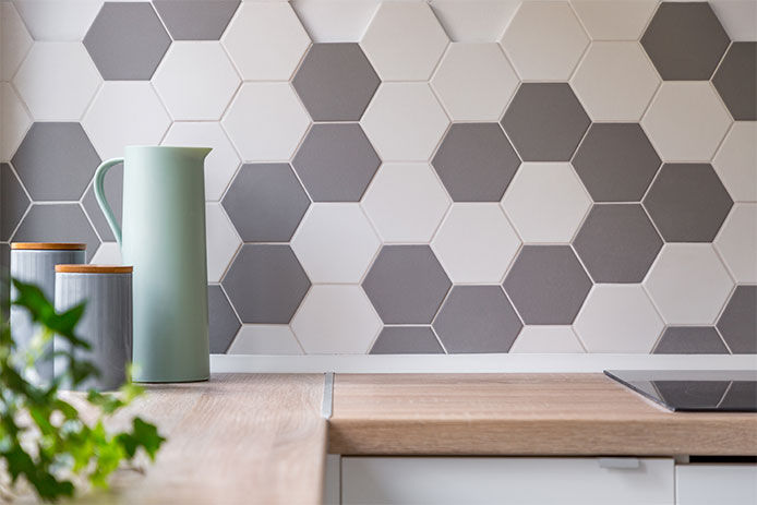 Kitchen with honeycomb wall tiles and wooden worktop