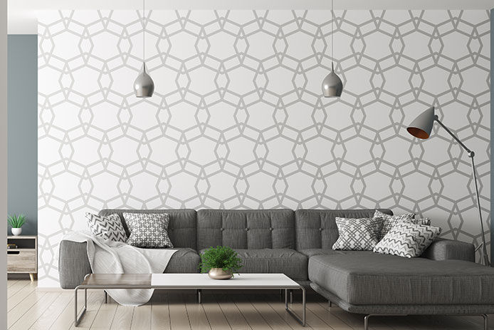 Modern interior of living room with black corner sofa and lamps over patterned wall