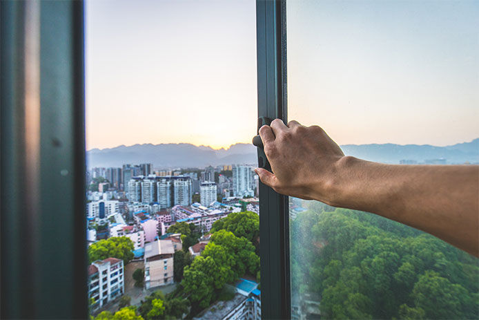 Good morning a man's hand opening a window