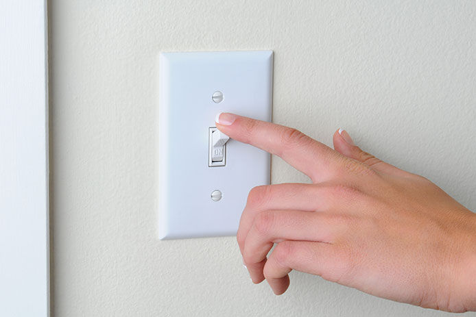 Person getting ready to flip a light switch