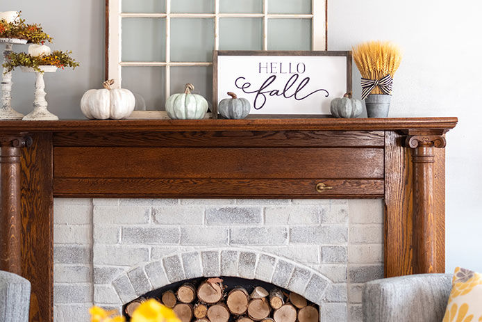 Stylish fall decorations on the mantel at home 
