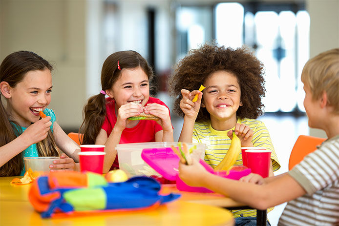 Kids eating lunch at a table