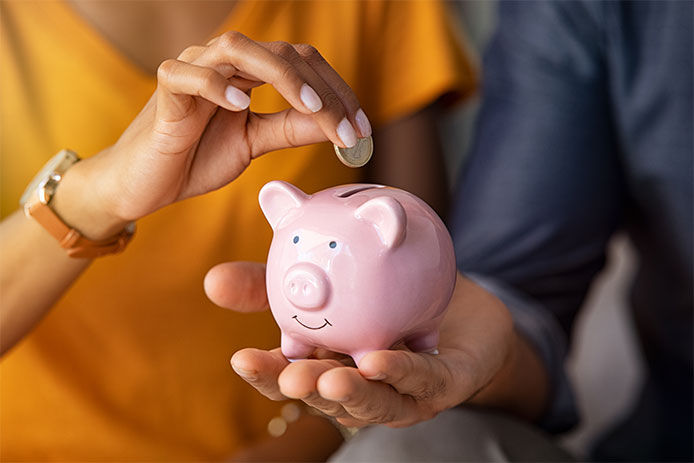 Putting coins into a piggybank