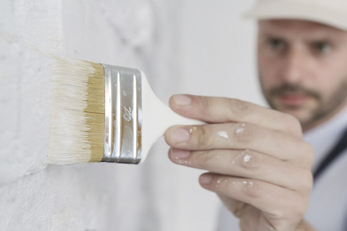 Man painting brick