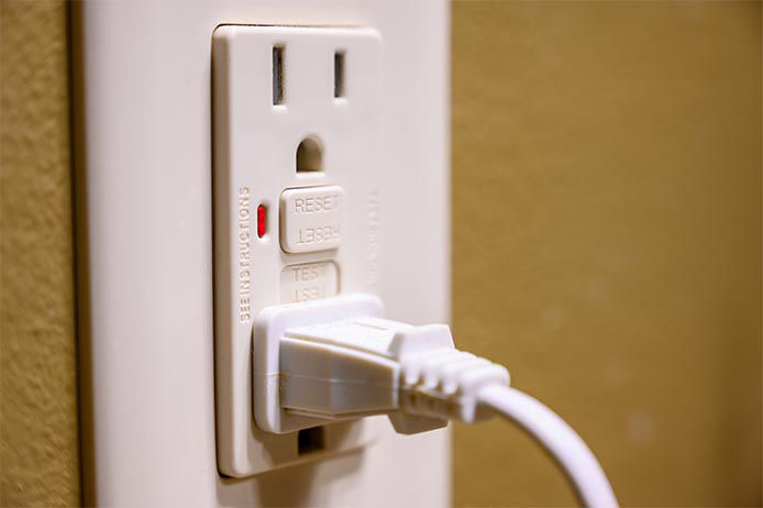 Plug plugged into a wall outlet