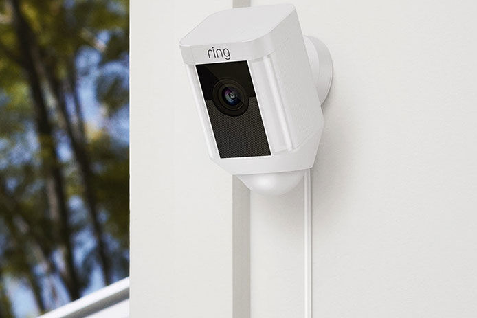 A Ring camera mounted and installed on the corner of a house