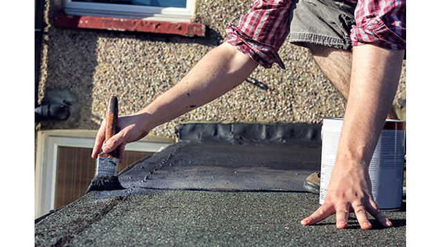 Man applying a roof coating