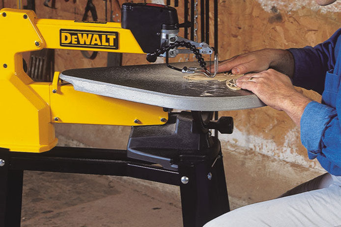 An older man working on a DEWALT scroll saw