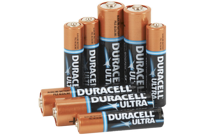 The image shows a group of Duracell Ultra batteries in AAA and AA size against a white background. The batteries are copper colored and black with a blue ring near the top.