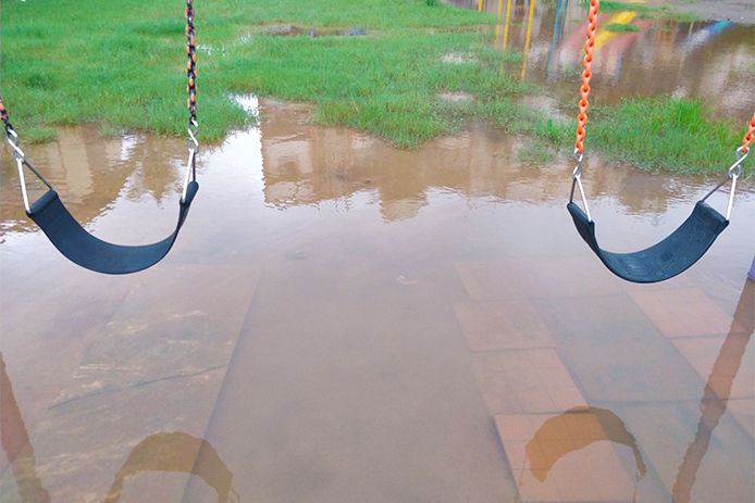 Water laying underneath a swing set