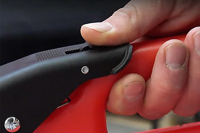Showing how to pull back the thumb safety on the SureCan