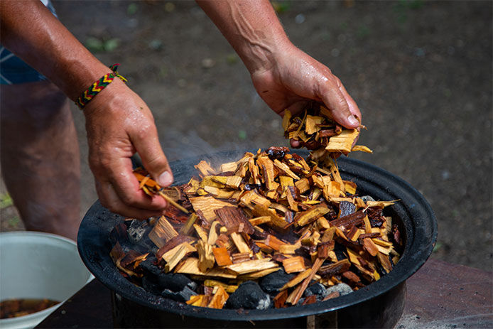 Person placing wood chips into pan