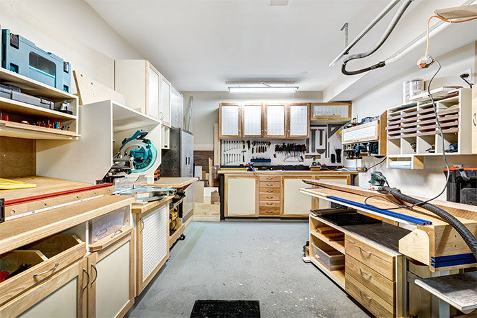 Workshop with plenty of work benches and cabinets for storage and workspace