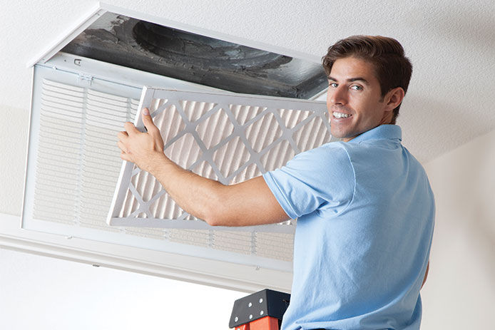 A man installing an air filter
