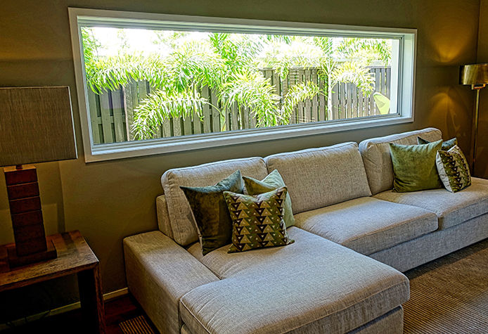 A couch in front of a large window