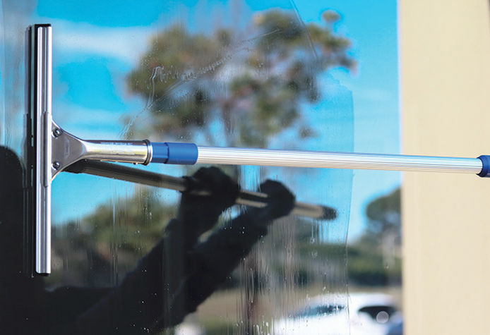 A person squeegeeing a window