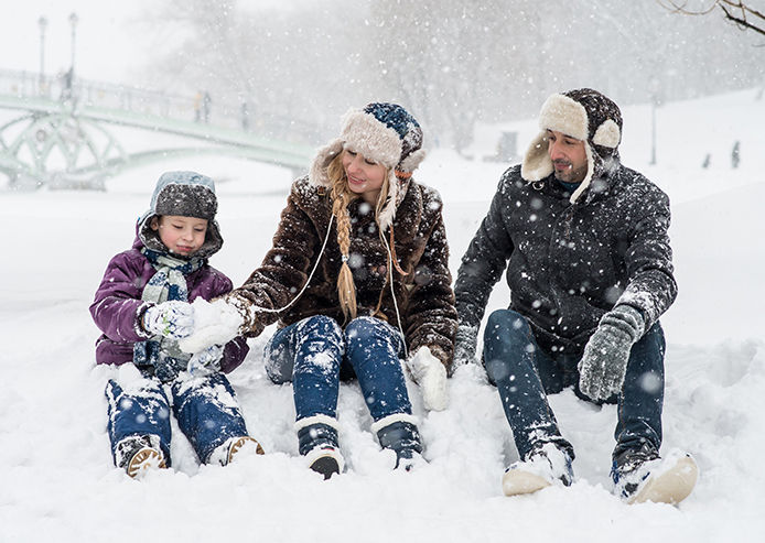 Family sitting in the snow