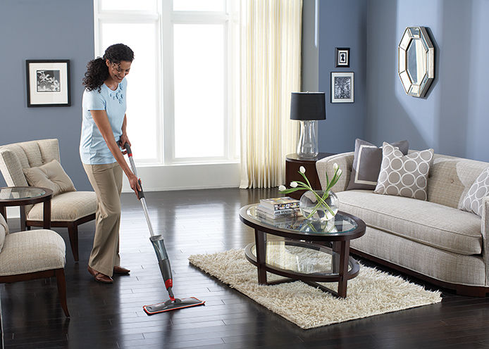 Woman cleaning wood floor
