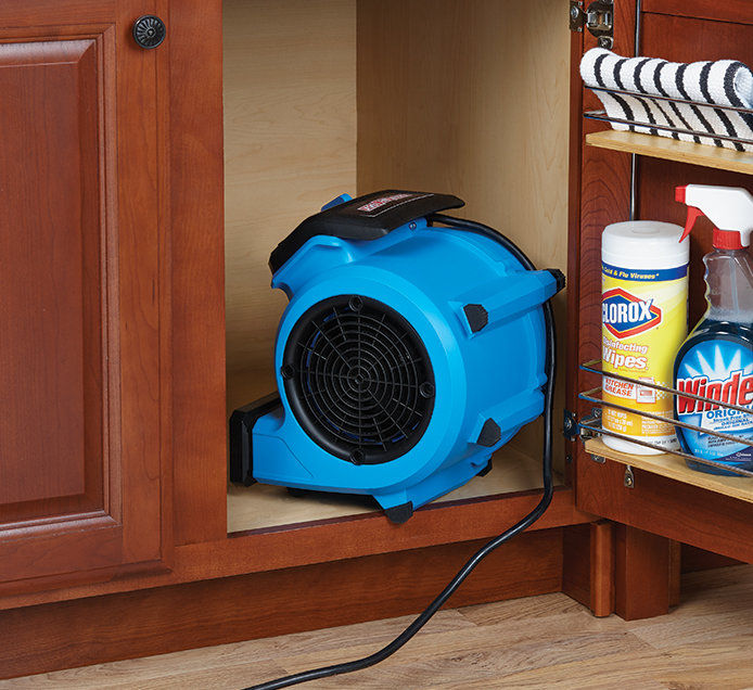 Fan blowing into kitchen cabinet