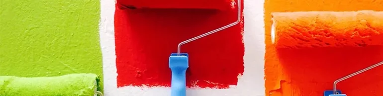 Three different paint rollers putting paint on a white wall