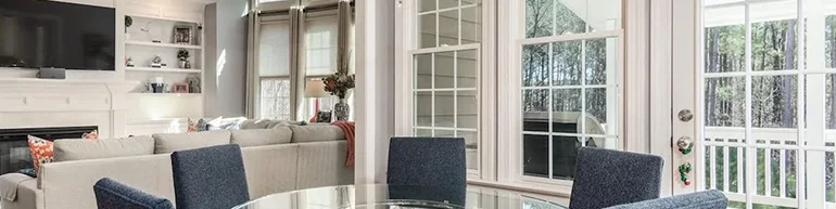 Image of an open and brightly lit living room with plenty of windows