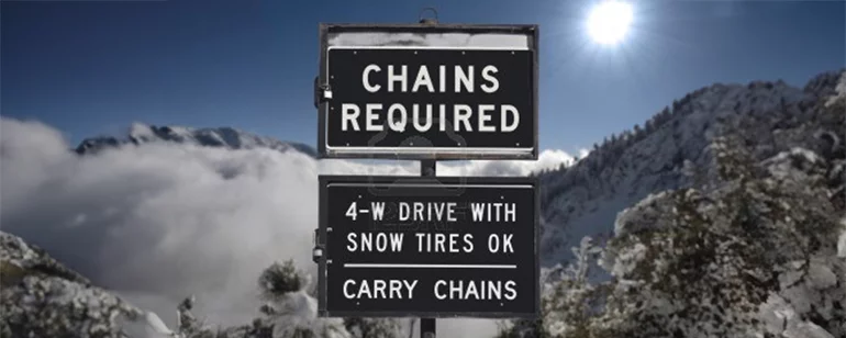 Chains Required sign in front of the mountains