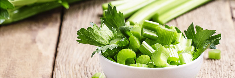 Cut up celery in a white bowl