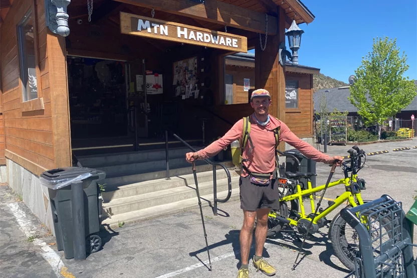 Adult man outside of Mountain Hardware ready to go hiking