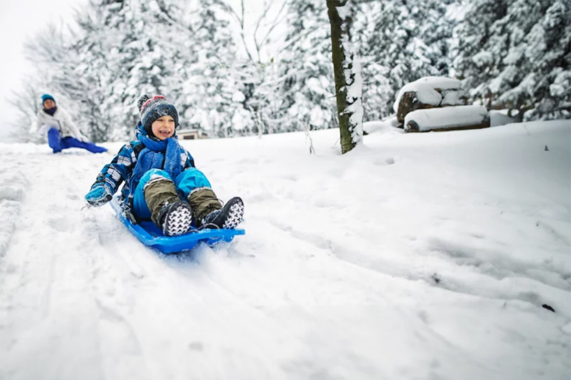 Kid Sledding down a hill