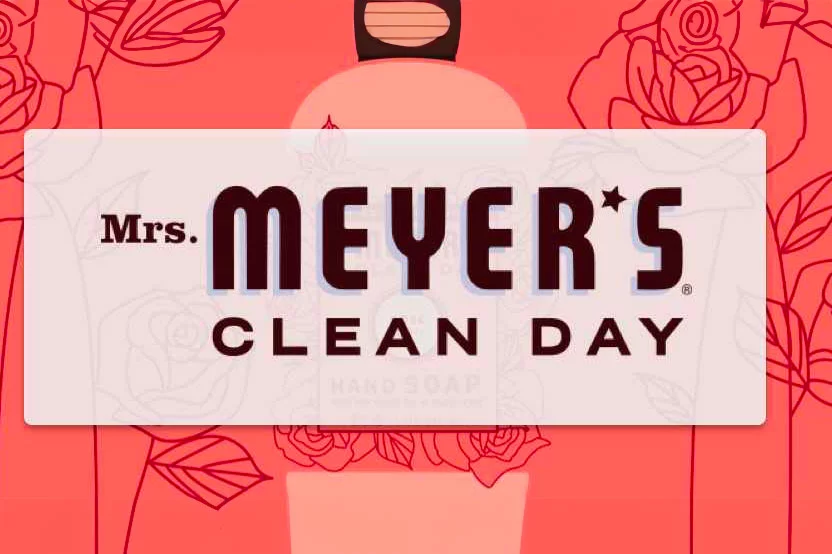 The Mrs. Meyers logo on a pink background of flowers.
