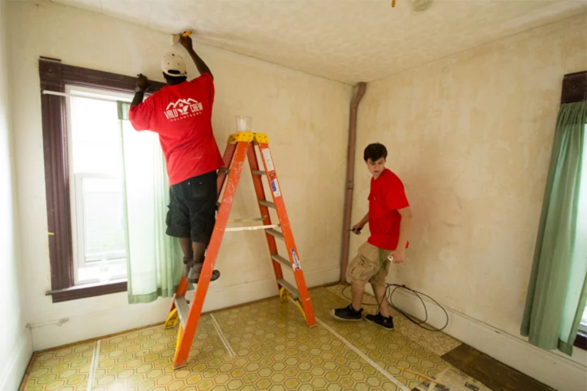 man painting inside home