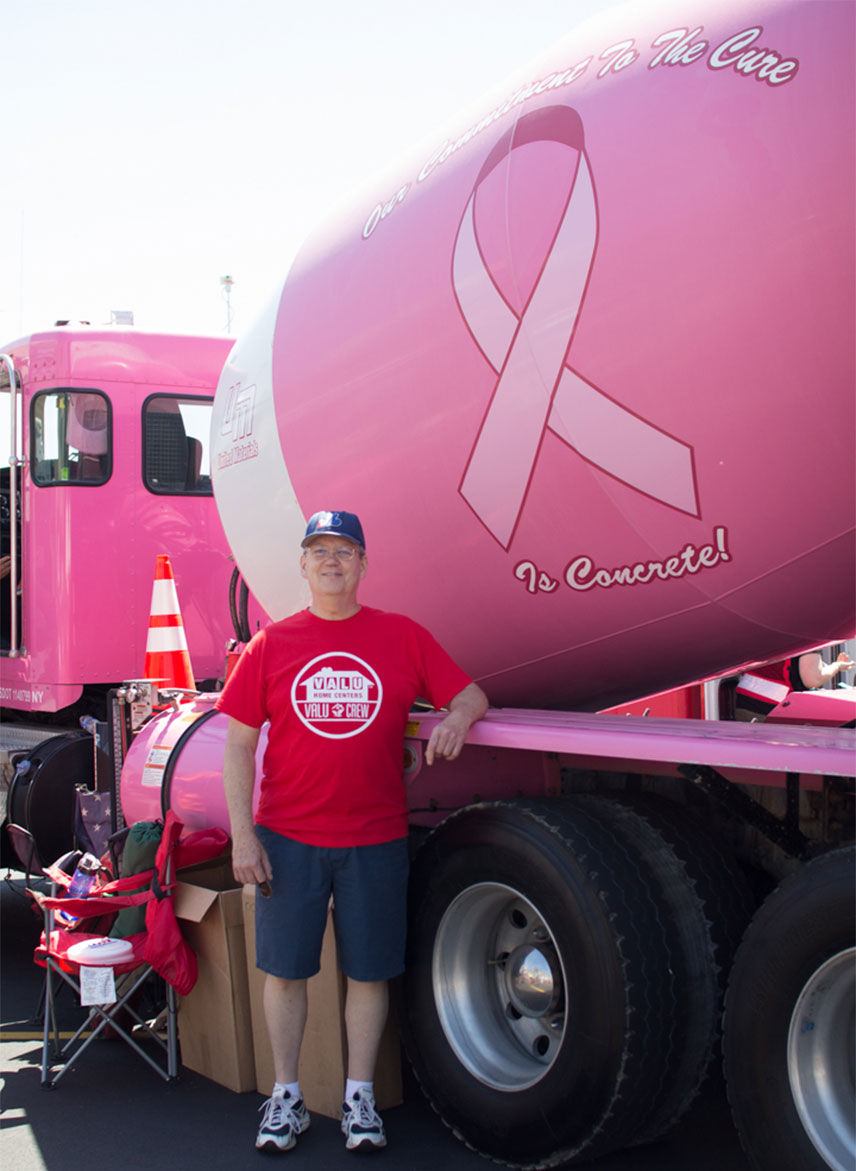 Valu team member standing in front of a Breast Cancer Awareness truck