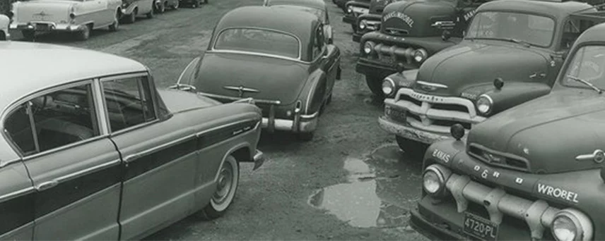 Historical image of cars parked at Banas Lumber & Hardware