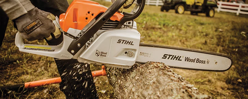 Man Sawing a Tree Branch With a STIHL Chainsaw