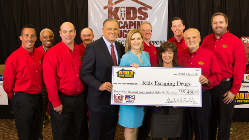 Check presentation with representatives from Valu and Kids Escaping Drugs
