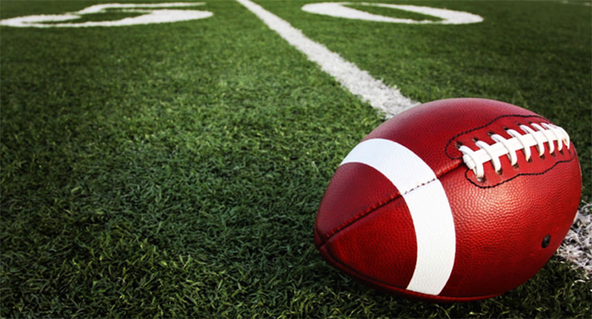 A football laying on a football field
