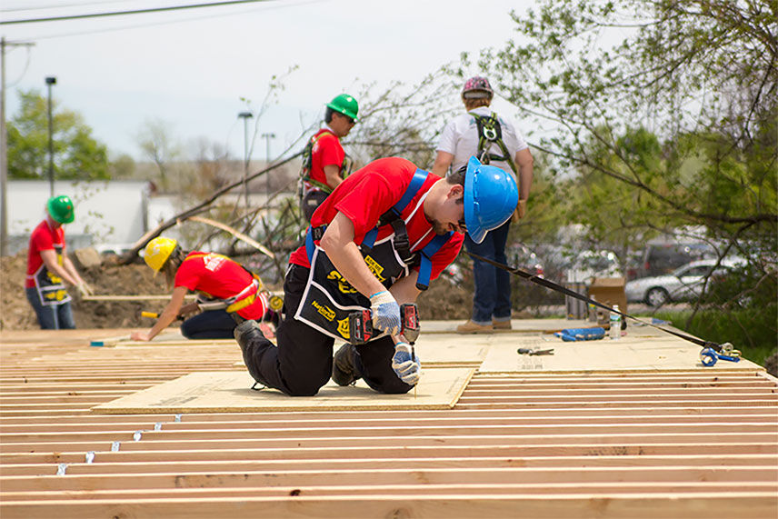 Vlau crew working on the frame of a home