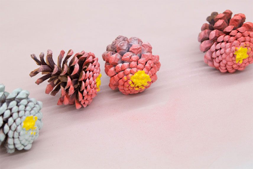 four painted pinecones to look like zinnia flowers 