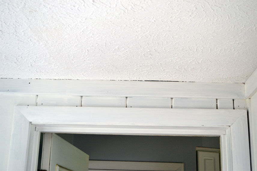 White primed paneling above a door frame