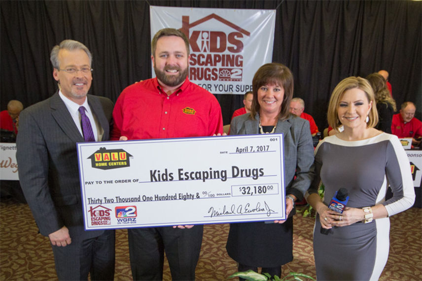 Valu crew holding check for donation