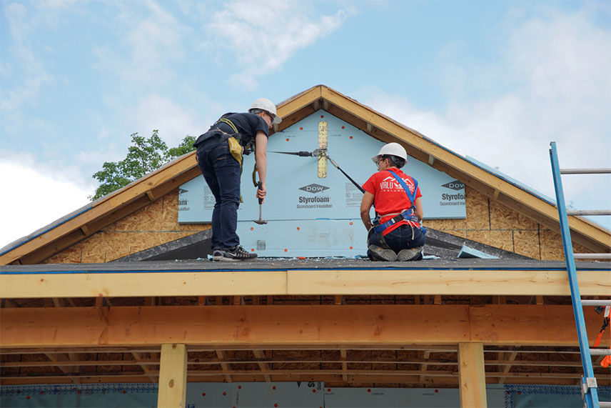 Valu team members working on the roof of the home