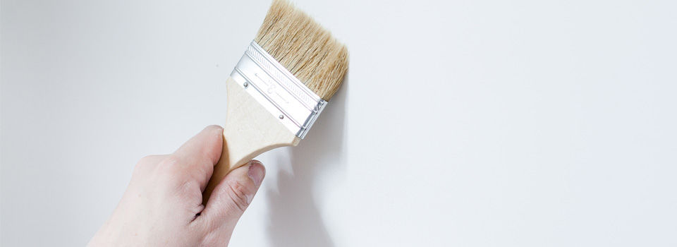 Person paintin white wall