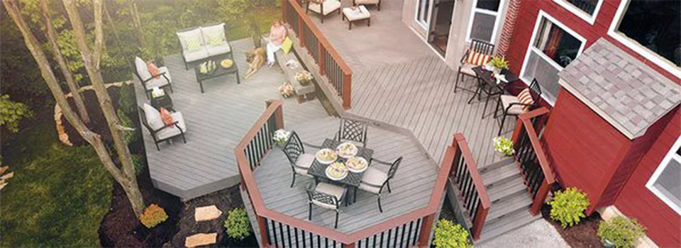 Top down view of a gray composite deck on the back of a red house 