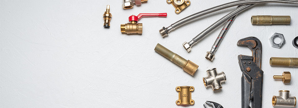 Plumbing equpment parts and wrenches on the white flat lay background with copy space. Pipeline parts.