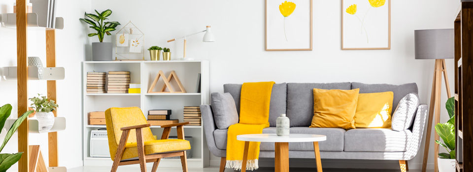 living room with couch and yellow accent furniture