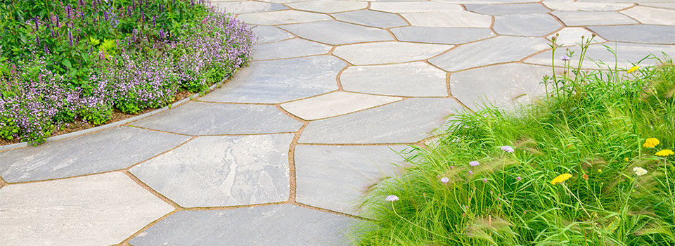 Flagstone pathway with garden beds on both the left and right side