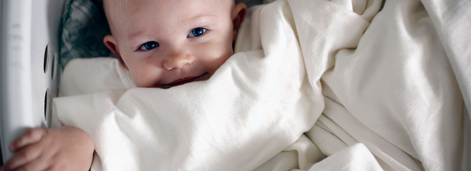 A baby in a laundry basket