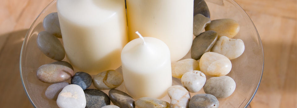 Unlit candle with rocks