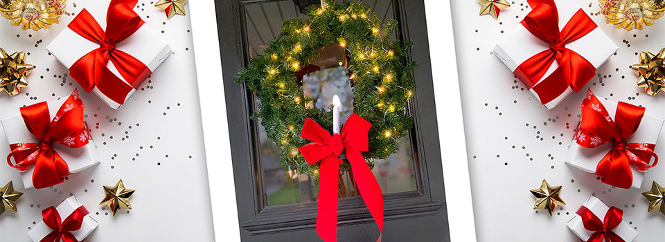 Holiday wreath on front door with battery-powered light